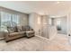 Upstairs loft area with comfortable seating and view of the staircase at 11902 Norfolk Ct, Commerce City, CO 80022