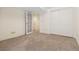 Basement area with neutral carpet, glass doors, closet and access to other rooms at 443 Garfield St, Denver, CO 80206