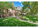 Charming home exterior with lush green lawn and mature trees at 443 Garfield St, Denver, CO 80206