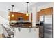 Kitchen featuring granite countertops, stainless steel appliances, and a convenient breakfast bar at 443 Garfield St, Denver, CO 80206