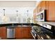 Bright kitchen features stainless steel appliances, granite countertops, and pendant lighting at 443 Garfield St, Denver, CO 80206