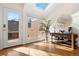 Sunlit living space with hardwood floors, skylight, and view of the outdoor patio at 443 Garfield St, Denver, CO 80206