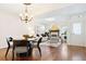Open-concept living and dining area with hardwood floors and a cozy fireplace at 443 Garfield St, Denver, CO 80206
