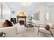Bright living room featuring a cozy fireplace, white walls, and neutral furniture at 443 Garfield St, Denver, CO 80206