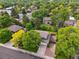 An aerial view shows a property with lots of mature landscaping and neighboring homes at 6898 W Nova Dr, Littleton, CO 80128