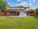 A well-kept backyard features an entertainment patio and a large grassy area at 6898 W Nova Dr, Littleton, CO 80128