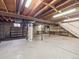 Unfinished basement with utility hookups, fluorescent lighting, and concrete flooring at 6898 W Nova Dr, Littleton, CO 80128