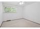 Minimalist bedroom featuring neutral carpet and a window at 6898 W Nova Dr, Littleton, CO 80128