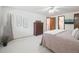 Cozy bedroom with neutral carpet, a dresser and access to an ensuite bathroom at 6898 W Nova Dr, Littleton, CO 80128