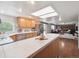 Open concept kitchen with counter seating, tile countertops and stainless steel appliances at 6898 W Nova Dr, Littleton, CO 80128