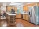 Bright eat-in kitchen with stainless steel appliances and wood cabinets at 6898 W Nova Dr, Littleton, CO 80128