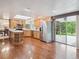 Bright kitchen with hardwood floors, stainless steel appliances, and sliding glass doors to the backyard at 6898 W Nova Dr, Littleton, CO 80128