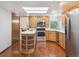 Bright eat-in kitchen with stainless steel appliances and wood cabinets at 6898 W Nova Dr, Littleton, CO 80128