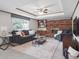Cozy living room featuring a brick fireplace and comfortable seating area at 6898 W Nova Dr, Littleton, CO 80128