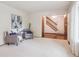 Inviting living room with comfortable seating and a view of the staircase at 6898 W Nova Dr, Littleton, CO 80128