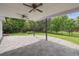 This shaded backyard patio includes lovely landscaping and ceiling fans for comfort at 6898 W Nova Dr, Littleton, CO 80128