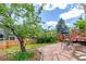 Backyard with a stone patio, lush lawn, and a wooden deck, perfect for outdoor enjoyment at 3186 W Indian Summer Ln, Castle Rock, CO 80109