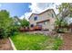 Backyard with a multi-tiered wooden deck and grassy lawn at 3186 W Indian Summer Ln, Castle Rock, CO 80109