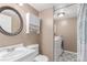 Bathroom featuring a vanity with sink, round mirror, toilet, and a shower/tub with curtain, plus laundry at 3186 W Indian Summer Ln, Castle Rock, CO 80109