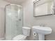 Bathroom featuring a modern shower stall, a pedestal sink, and neutral tones at 3186 W Indian Summer Ln, Castle Rock, CO 80109