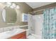 Bathroom features vanity with a single sink, an oval mirror, and a shower/tub combo at 3186 W Indian Summer Ln, Castle Rock, CO 80109