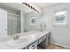 Bright bathroom featuring a large mirror, double sinks and tile flooring at 3186 W Indian Summer Ln, Castle Rock, CO 80109