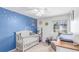 Bedroom with custom star wallpaper and a crib with a cute mobile hangs from the ceiling at 3186 W Indian Summer Ln, Castle Rock, CO 80109