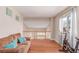Bright bonus room with hardwood floors, comfortable seating, and an exercise bike by the window at 3186 W Indian Summer Ln, Castle Rock, CO 80109