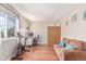 Versatile bonus room with hardwood floors, a comfortable couch, desk, and exercise equipment at 3186 W Indian Summer Ln, Castle Rock, CO 80109