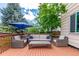 Deck with outdoor seating area featuring cushioned chairs, a sofa, and a coffee table at 3186 W Indian Summer Ln, Castle Rock, CO 80109