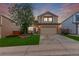 Charming two-story home boasts manicured lawn, brick accents and mature tree at 3186 W Indian Summer Ln, Castle Rock, CO 80109