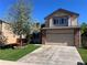 Inviting two-story home featuring a two-car garage and a well-manicured lawn at 3186 W Indian Summer Ln, Castle Rock, CO 80109