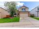 Charming two-story home boasts manicured lawn, brick accents and mature tree at 3186 W Indian Summer Ln, Castle Rock, CO 80109