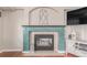 Close-up of the decorative fireplace with a unique mantel and tiled surround in the living room at 3186 W Indian Summer Ln, Castle Rock, CO 80109