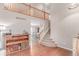 Bright foyer with hardwood floors, staircase, and a view into the dining room at 3186 W Indian Summer Ln, Castle Rock, CO 80109