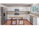 Spacious kitchen boasts stainless steel appliances, ample white cabinets, and a center island with bar stool seating at 3186 W Indian Summer Ln, Castle Rock, CO 80109