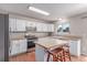 Bright kitchen featuring a center island, stainless steel appliances, and white cabinetry at 3186 W Indian Summer Ln, Castle Rock, CO 80109