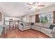 Spacious living area with hardwood floors, comfortable seating, and an open layout to the kitchen at 3186 W Indian Summer Ln, Castle Rock, CO 80109