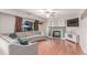 Cozy living room featuring a plush sectional sofa, hardwood floors, and a fireplace at 3186 W Indian Summer Ln, Castle Rock, CO 80109