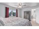 Comfortable bedroom with a ceiling fan, large window, and a view of the outside at 3186 W Indian Summer Ln, Castle Rock, CO 80109