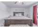 Main bedroom features a dark wood bed frame, neutral carpet, natural light, and a ceiling fan at 3186 W Indian Summer Ln, Castle Rock, CO 80109