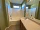 Clean, bright bathroom featuring a shower-tub combo and vanity at 407 Ivory Cir, Aurora, CO 80011