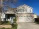 Two-story home with a two-car garage and a well-maintained front yard at 407 Ivory Cir, Aurora, CO 80011