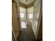 Hallway with carpet and doors leading to bedrooms with lots of natural light at 407 Ivory Cir, Aurora, CO 80011