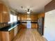 Well-lit kitchen with wood cabinets, granite countertops, and stainless steel appliances at 407 Ivory Cir, Aurora, CO 80011