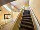 Carpeted staircase leading to upper level, with view of living room below at 407 Ivory Cir, Aurora, CO 80011
