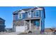 Charming two-story home with blue siding, stone accents, a two-car garage and covered front porch at 758 N Clubview St, Watkins, CO 80137