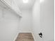 Walk-in closet features white walls, shelving, and wood-look flooring at 2800 Kalmia Ave # C101, Boulder, CO 80301