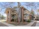 Apartment building featuring stairwells leading to private balconies, brick facade, and mature trees providing shade at 2800 Kalmia Ave # C101, Boulder, CO 80301