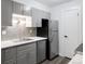 Functional kitchen with stainless steel appliances, gray cabinets and backsplash, and white countertops for a clean look at 2800 Kalmia Ave # C101, Boulder, CO 80301